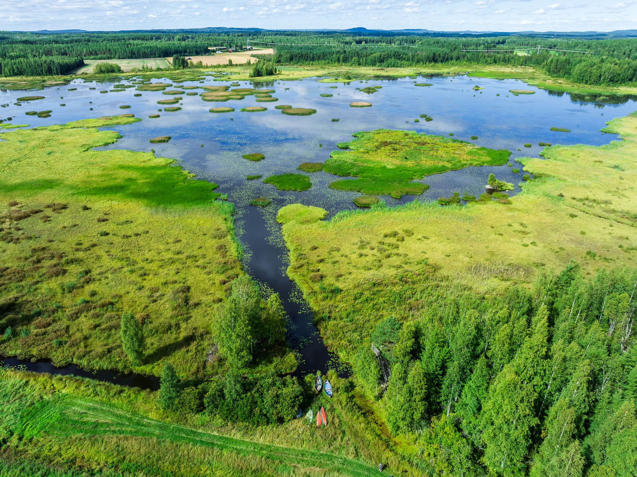 Ilmakuvassa vettä, metsää, peltoa ja kosteikkoa.